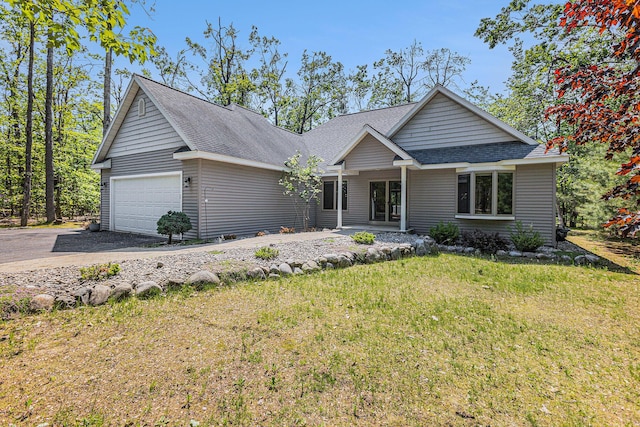 6296 Wolverine Trl, Gaylord, MI 49735 - view of front of property with roof with shingles, a front yard, an attached garage, and concrete driveway