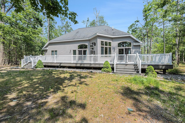 6296 Wolverine Trl, Gaylord, MI 49735 - back of house with a deck and a shingled roof