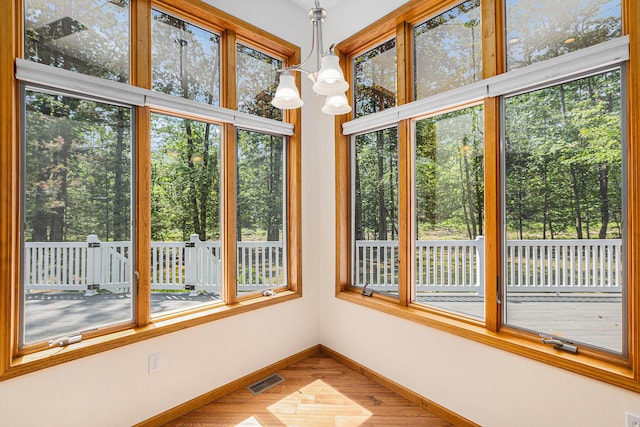 6296 Wolverine Trl, Gaylord, MI 49735 - unfurnished sunroom featuring healthy amount of natural light and wood finished floors