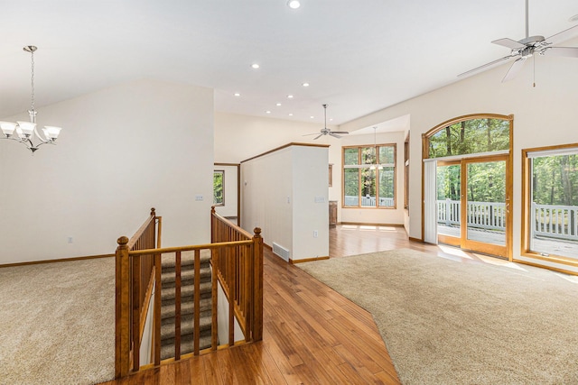 6296 Wolverine Trl, Gaylord, MI 49735 - empty room featuring a ceiling fan, vaulted ceiling, a chandelier, light wood-style floors, and recessed lighting