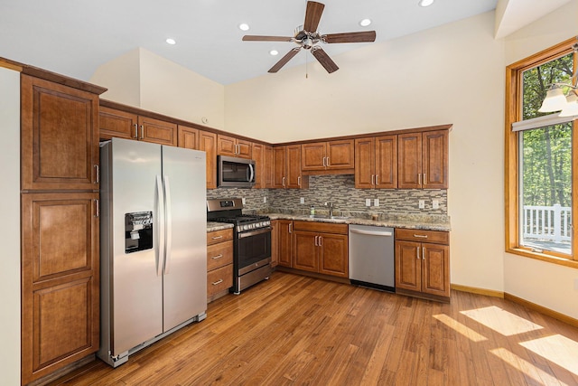 6296 Wolverine Trl, Gaylord, MI 49735 - kitchen featuring stainless steel appliances, light wood-style floors, brown cabinets, a ceiling fan, and recessed lighting