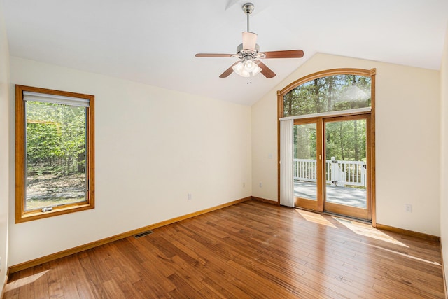 6296 Wolverine Trl, Gaylord, MI 49735 - unfurnished room with plenty of natural light, lofted ceiling, wood-type flooring, and a ceiling fan