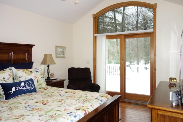 6296 Wolverine Trl, Gaylord, MI 49735 - bedroom with access to outside, vaulted ceiling, and wood finished floors