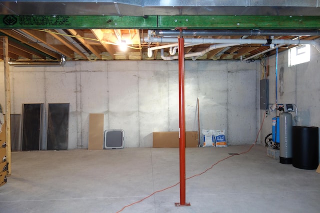 6296 Wolverine Trl, Gaylord, MI 49735 - unfinished basement featuring a water softener and electric panel