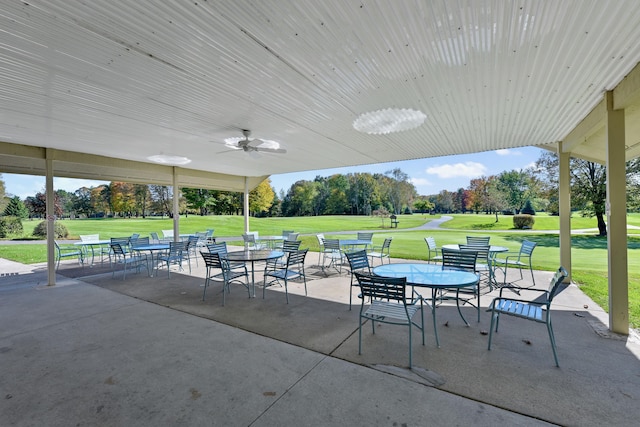 6296 Wolverine Trl, Gaylord, MI 49735 - view of patio featuring a ceiling fan, outdoor dining area, and golf course view