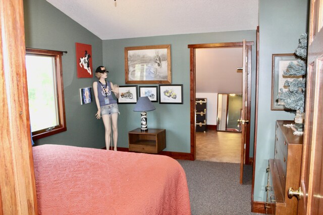 3009 NE Trl, Grayling, MI 49738 - carpeted bedroom featuring vaulted ceiling and baseboards