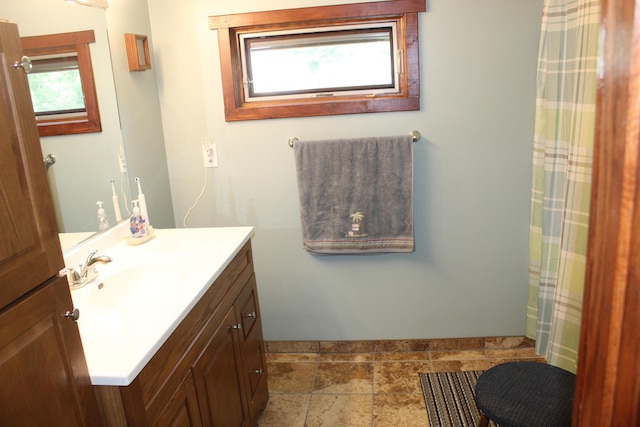 3009 NE Trl, Grayling, MI 49738 - full bathroom featuring vanity, stone tile flooring, and a shower with curtain