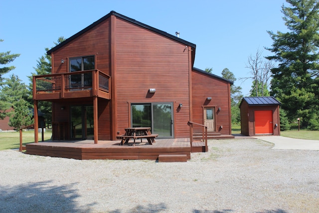 3009 NE Trl, Grayling, MI 49738 - back of property featuring a storage unit and a deck