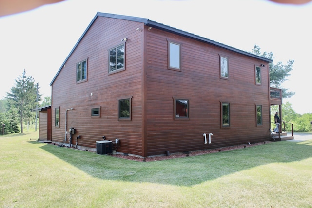 3009 NE Trl, Grayling, MI 49738 - view of home's exterior featuring a lawn and a central AC unit