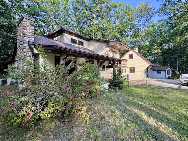 5200 Pine Grove Dr, Spruce, MI 48762 - view of front of property with a chimney and a front lawn
