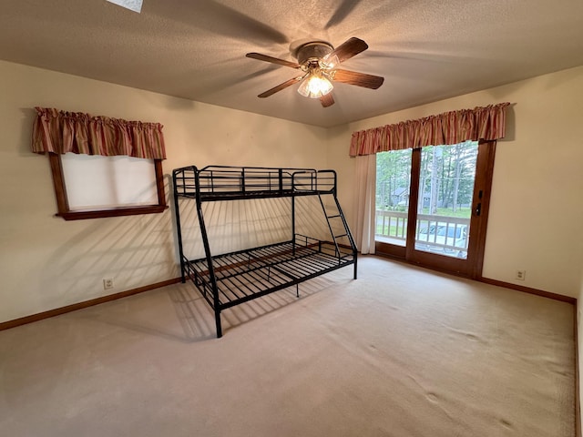 5200 Pine Grove Dr, Spruce, MI 48762 - carpeted bedroom featuring access to exterior and a textured ceiling