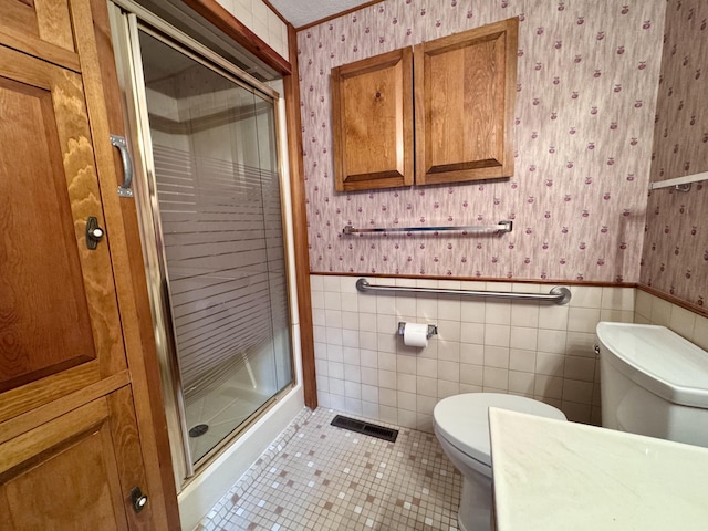5200 Pine Grove Dr, Spruce, MI 48762 - bathroom featuring wallpapered walls, a wainscoted wall, a shower stall, tile patterned floors, and tile walls