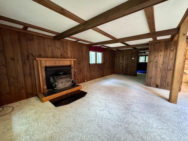 5200 Pine Grove Dr, Spruce, MI 48762 - unfurnished living room featuring carpet floors, wooden walls, a wood stove, beamed ceiling, and coffered ceiling