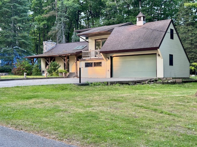 5200 Pine Grove Dr, Spruce, MI 48762 - view of front of house featuring a chimney, a garage, a front lawn, and a balcony