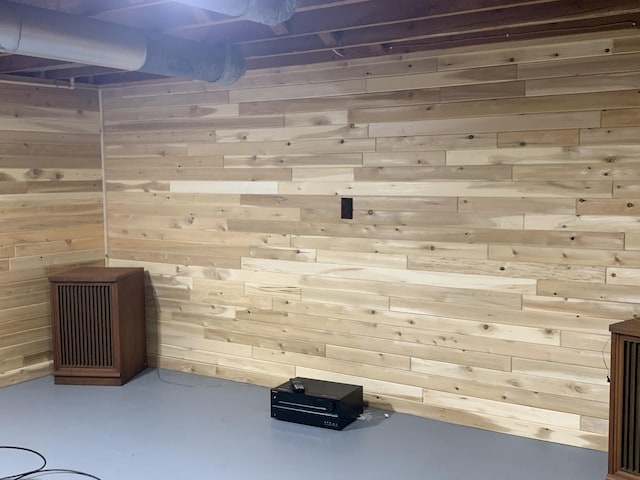 185 S June St, Alpena, MI 49707 - interior space with wooden walls and finished concrete flooring