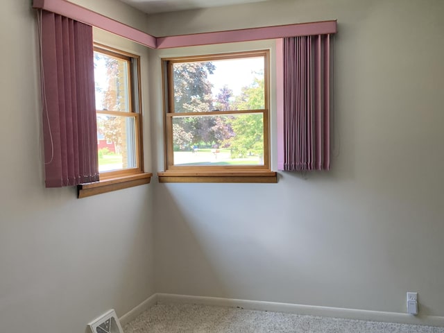 185 S June St, Alpena, MI 49707 - carpeted empty room featuring healthy amount of natural light