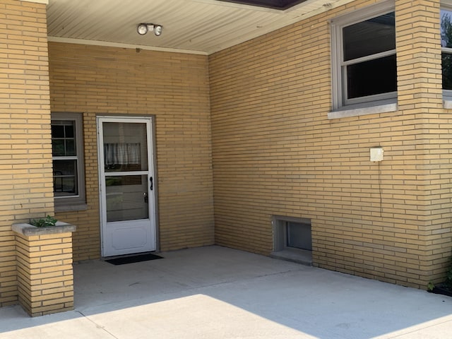 185 S June St, Alpena, MI 49707 - entrance to property featuring brick siding and a patio area