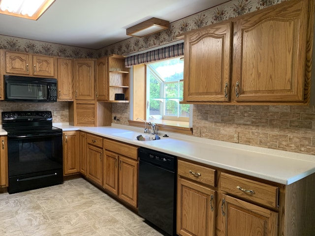 185 S June St, Alpena, MI 49707 - kitchen featuring black appliances, decorative backsplash, light countertops, and open shelves