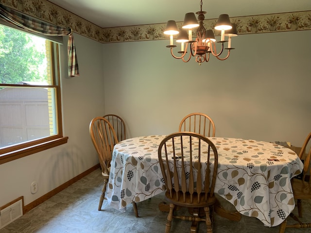 185 S June St, Alpena, MI 49707 - dining space featuring a chandelier and baseboards