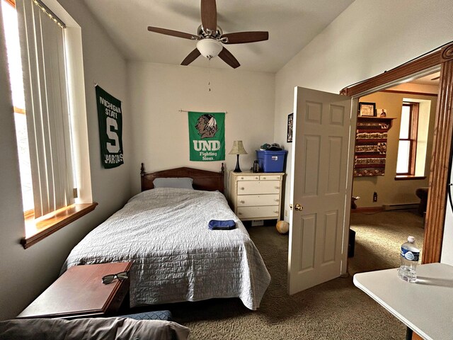 380 Church St, Saint Ignace, MI 49781 - carpeted bedroom with a ceiling fan and a baseboard radiator