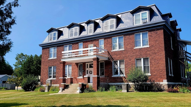 380 Church St, Saint Ignace, MI 49781 - view of front of house featuring a balcony, brick siding, and a front yard
