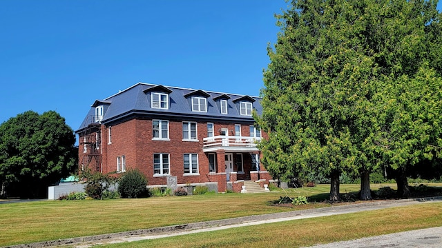 380 Church St, Saint Ignace, MI 49781 - colonial house with a balcony, brick siding, and a front yard