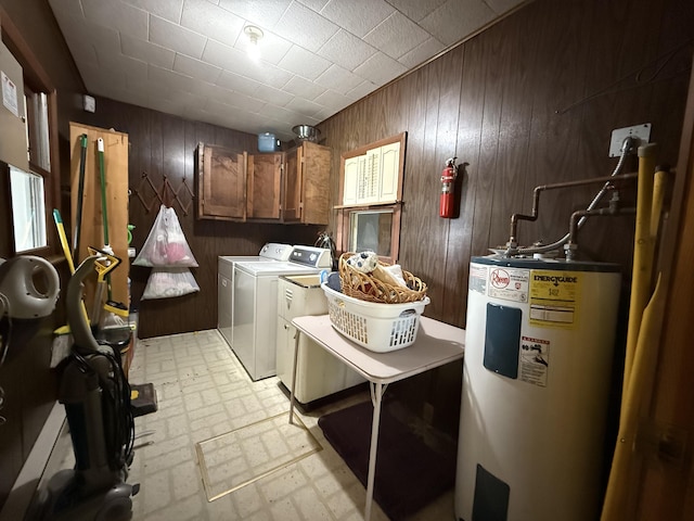 5913 M-33, Cheboygan, MI 49721 - laundry area with electric water heater, wood walls, independent washer and dryer, cabinet space, and brick patterned floors