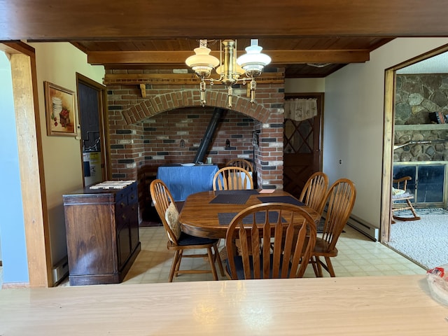 5913 M-33, Cheboygan, MI 49721 - dining area with tile patterned floors, a wood ceiling with exposed beams, a wood stove, a chandelier, and a baseboard radiator