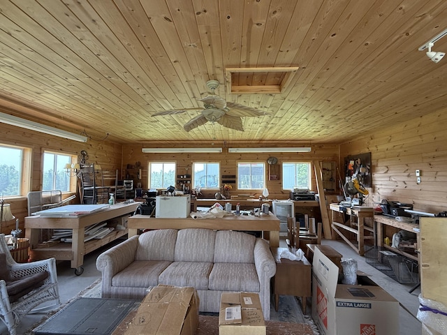 5913 M-33, Cheboygan, MI 49721 - living area with wooden ceiling, wooden walls, and ceiling fan