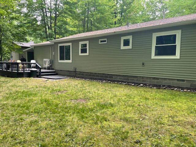 95 Caduca Ln, Roscommon, MI 48653 - back of property with a wooden deck, a lawn, and crawl space