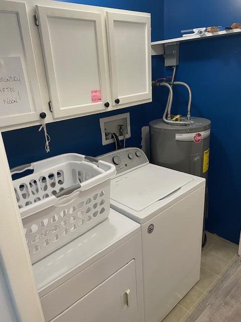 95 Caduca Ln, Roscommon, MI 48653 - laundry area featuring cabinet space, separate washer and dryer, and water heater