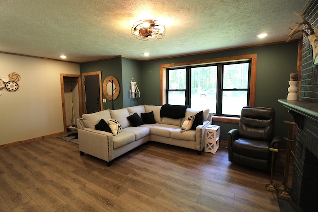 211 Daytona Rd, Roscommon, MI 48653 - living area with a large fireplace, a textured ceiling, dark wood-type flooring, and recessed lighting