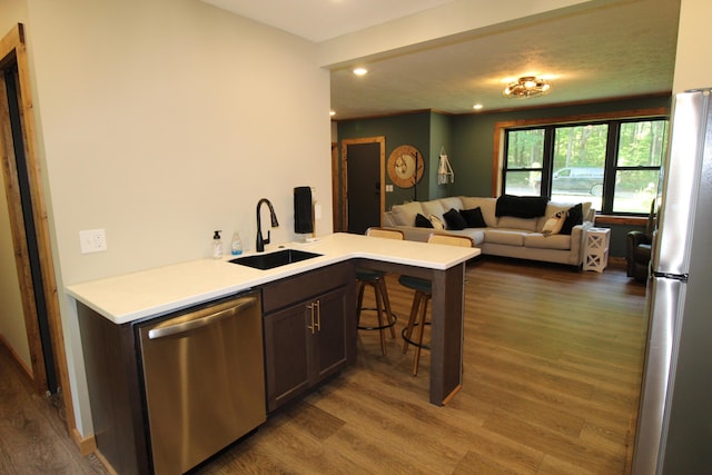 211 Daytona Rd, Roscommon, MI 48653 - kitchen with stainless steel appliances, open floor plan, recessed lighting, wood finished floors, and light countertops