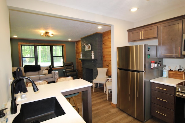 211 Daytona Rd, Roscommon, MI 48653 - kitchen with appliances with stainless steel finishes, light wood-type flooring, light countertops, open floor plan, and recessed lighting