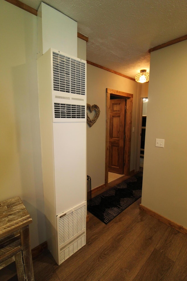 211 Daytona Rd, Roscommon, MI 48653 - hall featuring a heating unit, wood finished floors, ornamental molding, and a textured ceiling
