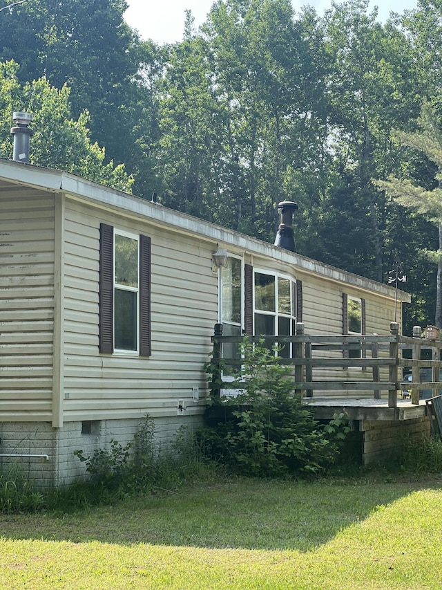 577 Wilderness Trl, Saint Helen, MI 48656 - view of front of home with a front lawn, a wooden deck, and crawl space