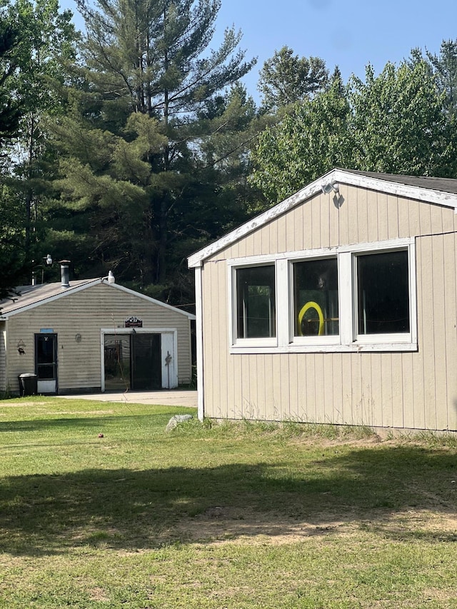 577 Wilderness Trl, Saint Helen, MI 48656 - view of property exterior featuring a lawn and an outbuilding