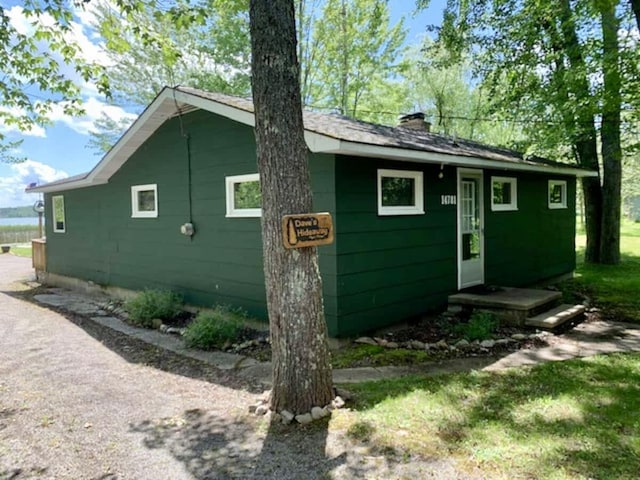 14781 Shubert Hwy, Posen, MI 49776 - view of side of property with a chimney