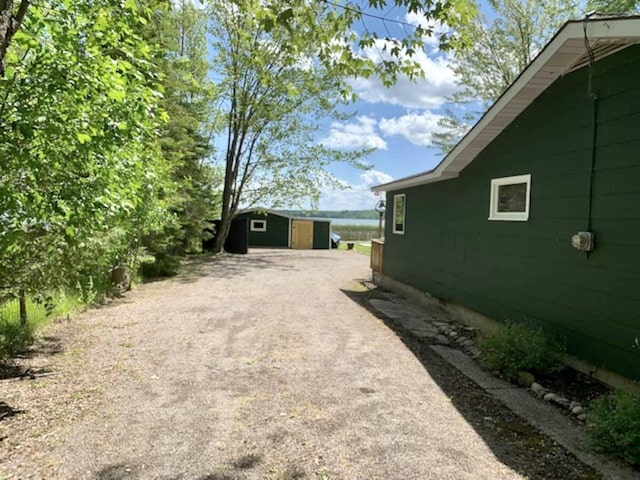 14781 Shubert Hwy, Posen, MI 49776 - view of yard with driveway and a shed