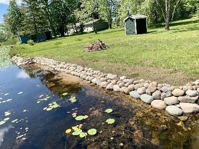 14781 Shubert Hwy, Posen, MI 49776 - view of green lawn with a shed