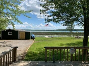 14781 Shubert Hwy, Posen, MI 49776 - view of property's community with a deck with water view and a yard