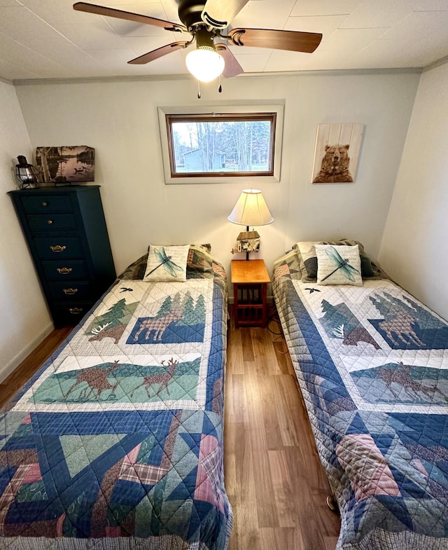 14781 Shubert Hwy, Posen, MI 49776 - bedroom with wood finished floors and ceiling fan
