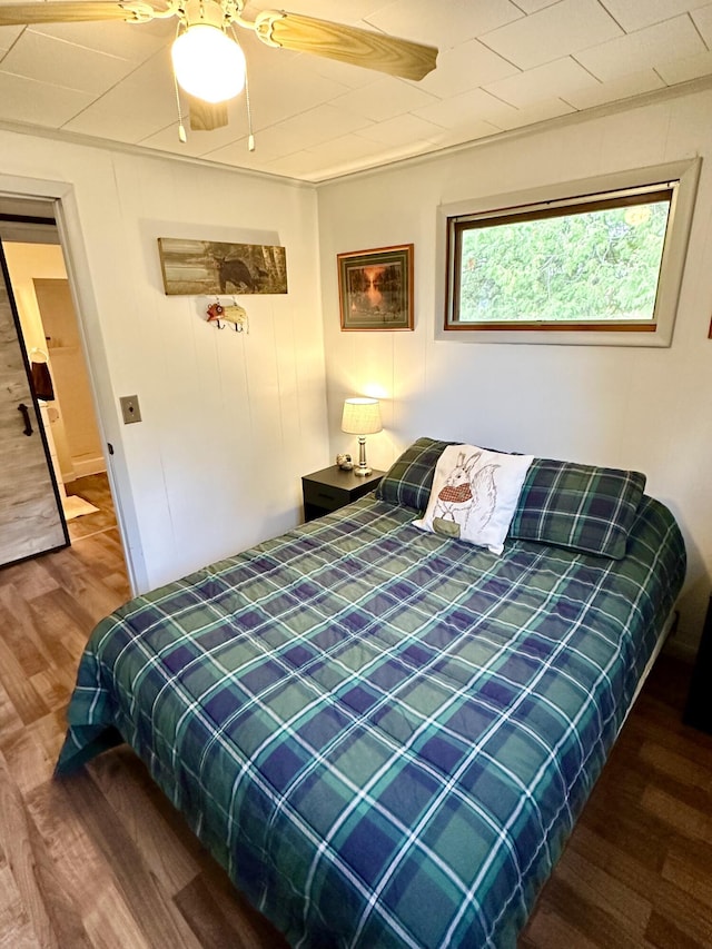 14781 Shubert Hwy, Posen, MI 49776 - bedroom featuring wood finished floors and a ceiling fan