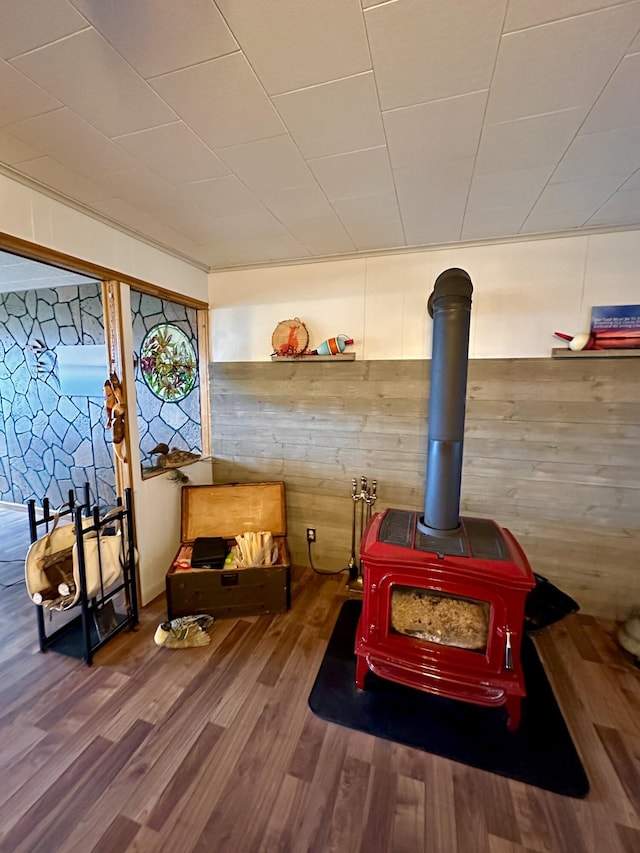14781 Shubert Hwy, Posen, MI 49776 - detailed view of wooden walls, wood finished floors, and a wood stove