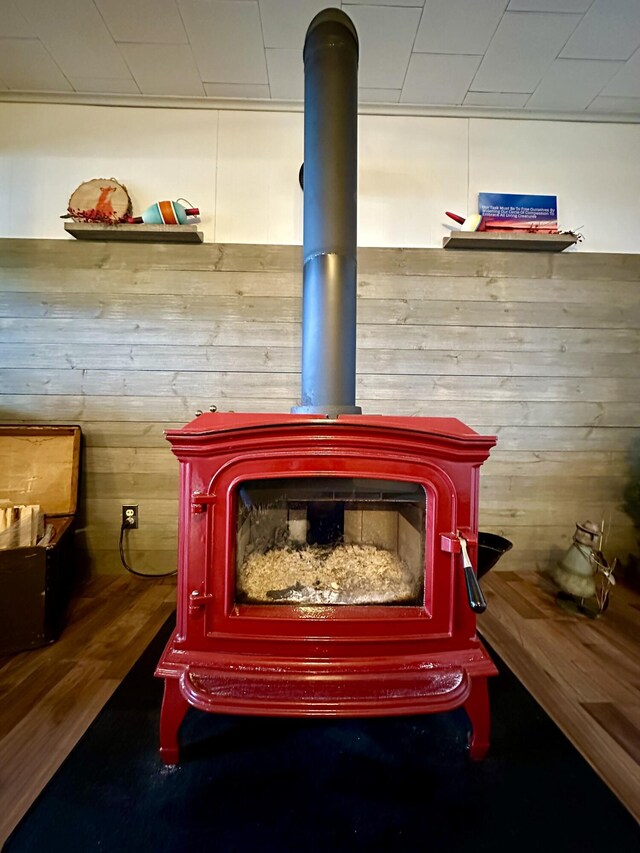 14781 Shubert Hwy, Posen, MI 49776 - detailed view of a wood stove, wood walls, and wood finished floors