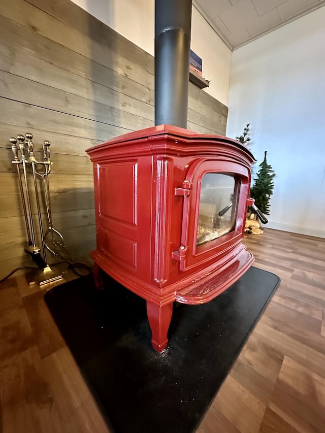 14781 Shubert Hwy, Posen, MI 49776 - detailed view of a wood stove, wood walls, and wood finished floors