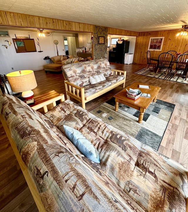 14781 Shubert Hwy, Posen, MI 49776 - living room featuring wooden walls and wood finished floors