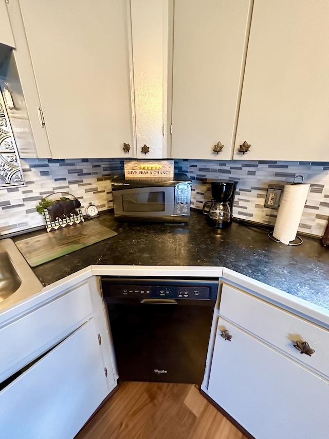 14781 Shubert Hwy, Posen, MI 49776 - kitchen with dishwasher, stainless steel microwave, white cabinetry, and tasteful backsplash