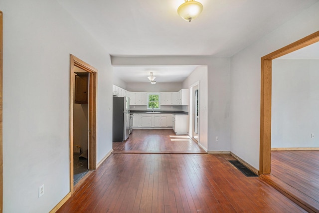 1014 Court St, Cheboygan, MI 49721 - hallway featuring a sink and dark wood-type flooring