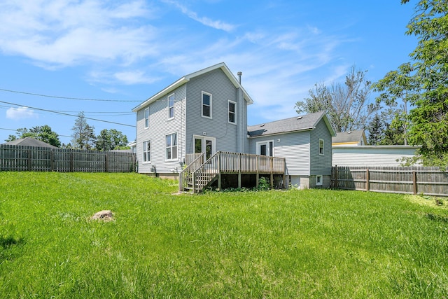 1014 Court St, Cheboygan, MI 49721 - back of property with a deck and a fenced backyard